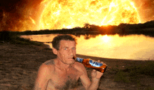 a shirtless man is drinking from a bottle that says ' s.p.p. ' on it