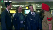 a group of people are standing next to each other in an airport .