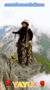 a picture of a woman standing on top of a mountain with the name yayuk