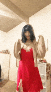 a woman in a red dress has a heart tattoo on her neck