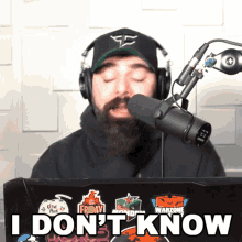 a man with a beard is wearing headphones and a hat that says faze clan