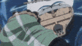 a man in a plaid shirt is standing next to a boat in the ocean .