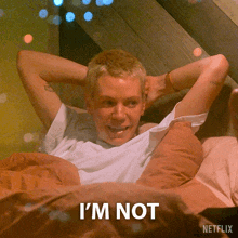 a man is laying in bed with his hands behind his head and the words i 'm not written on the bottom