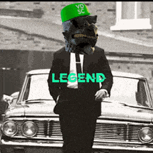 a man in a suit and tie with a green hat that says vd sc on it