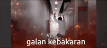 a man is standing in a hallway with the words kebakar galan kebakaran