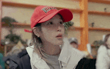 a woman wearing a red baseball cap with the word williams on it .