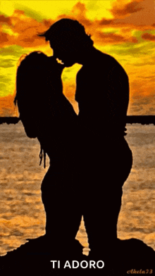 a silhouette of a man and a woman kissing with the caption ti adoro