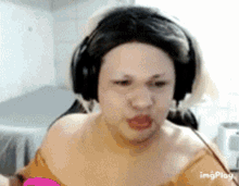 a woman wearing headphones and a wig is making a face