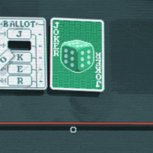 a joker playing card with a green dice on it