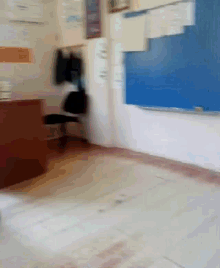 a blurry picture of a classroom with a blue board and a chair