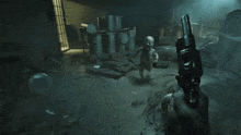 a person standing in a dark room with a bunch of trash cans on the floor