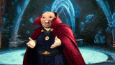 a cartoon character with a red cape and a gold necklace is standing in front of a blue background