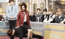 a man is doing a handstand while a woman sits on his back
