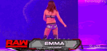 a woman is dancing on a stage in front of a purple wall .