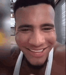 a close up of a man 's face with a smile on his face .