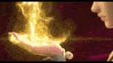 a woman is holding a fire in her hand .