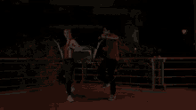 a man and a woman are running at night on a bridge