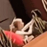 a blurry picture of a person laying on a couch with a plant .