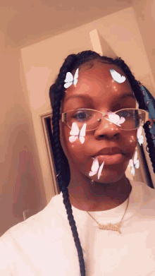 a young girl wearing glasses and a necklace with the name sarah on it