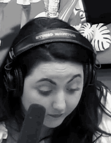 a woman wearing a pair of headphones that say stereo monitor