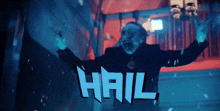 a man with a beard is standing in front of a sign that says hail