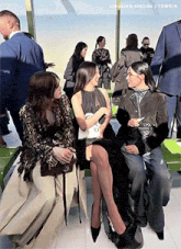 a group of women are sitting on a bench with a tumblr logo on the bottom right