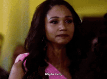 a woman in a pink dress is saying maybe i am