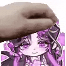 a hand is holding a picture of a cartoon girl with purple hair .