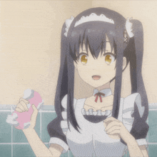 a girl in a maid outfit is holding a pink object in her hand