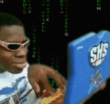 a man wearing sunglasses looks at a shs box