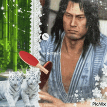 a picture of a man playing ping pong with two white tiger cubs