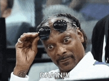 snoop dogg is wearing sunglasses and has the word damn written on his face