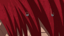 a close up of a person 's eyes with red hair .