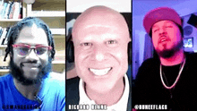 three men are sitting next to each other and smiling at the camera .