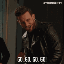 a man in a leather jacket says " go go go go "