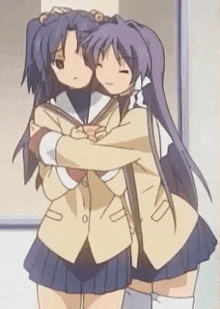two anime girls are hugging each other in front of a wall .