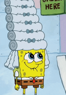 a cartoon character named spongebob has a stack of towels on his head
