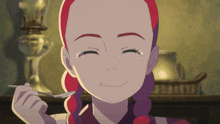 a girl with red hair is smiling while holding a spoon in her hand