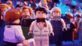 a group of lego minifigures are standing in a crowd .