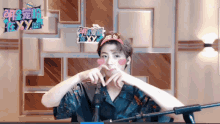 a man making a heart shape with his hands with a sign that says sexy