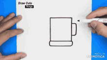 a person is drawing a cup with a marker on a piece of paper that says draw cute things on it
