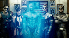 a group of superheros are posing for a picture with an american flag in the background