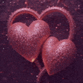 a man in a white shirt stands in front of a large pink heart