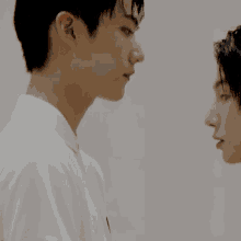 two young men are looking at each other in a room .