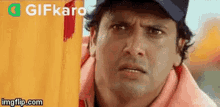 a man wearing a hat and a life jacket is looking at the camera .