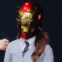 a woman wearing a helmet that looks like an iron man helmet