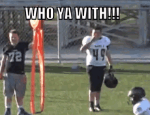 a football player with the number 49 on his jersey stands next to another player
