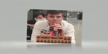 a picture of a young man drinking a coke with a sign that says my honest reaction