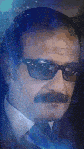 a man with glasses and a mustache has a blue background