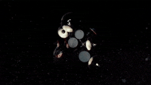 a man playing drums in a dark room with smoke coming out of it